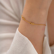 Parure Infini collier et bracelet dorés en acier inoxydable et PVD 18K